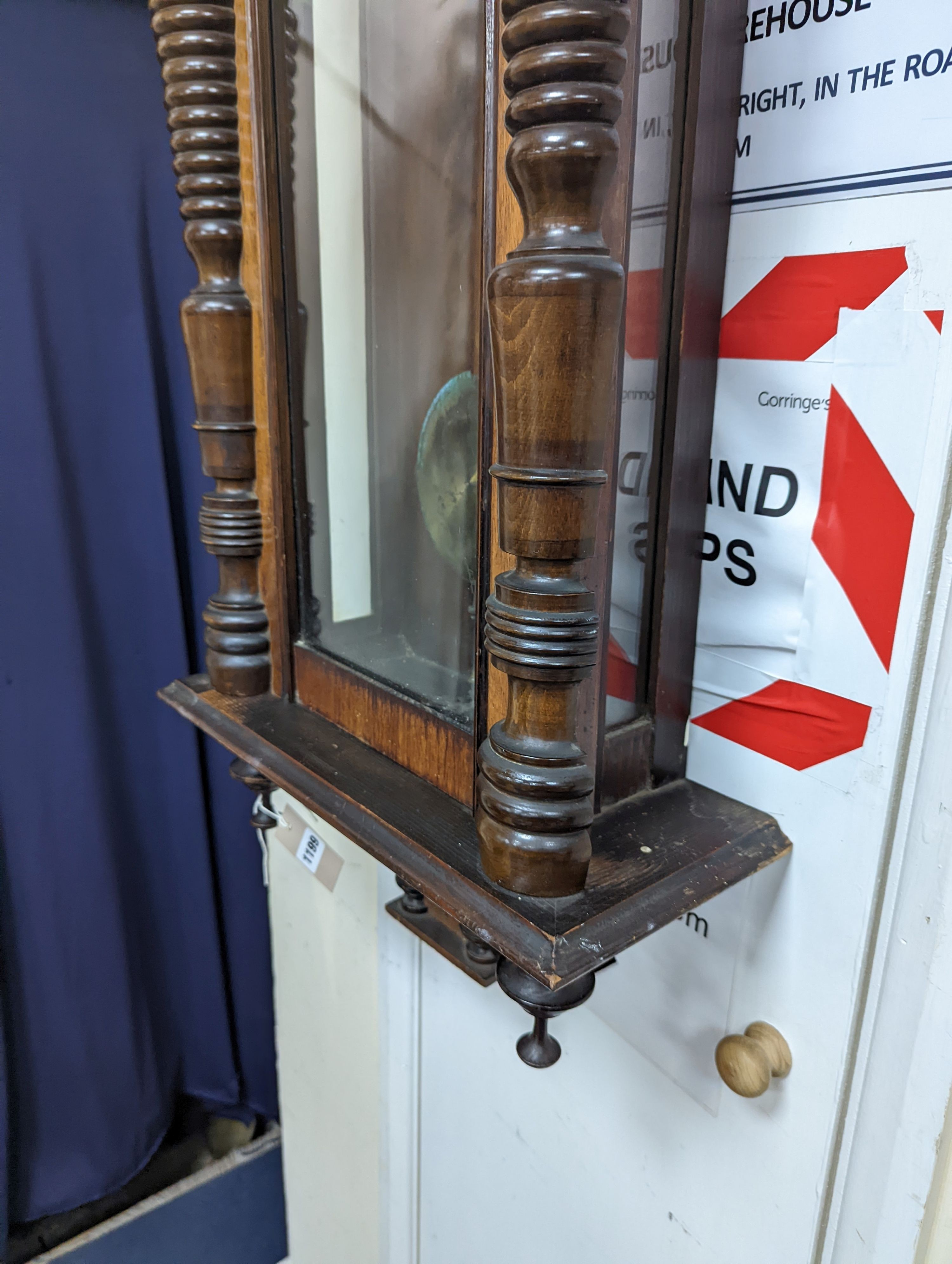A late 19th century Austrian walnut wall clock, with key and pendulum, height 118cm